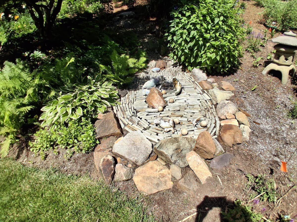 Stone water feature and surrounding planting bed